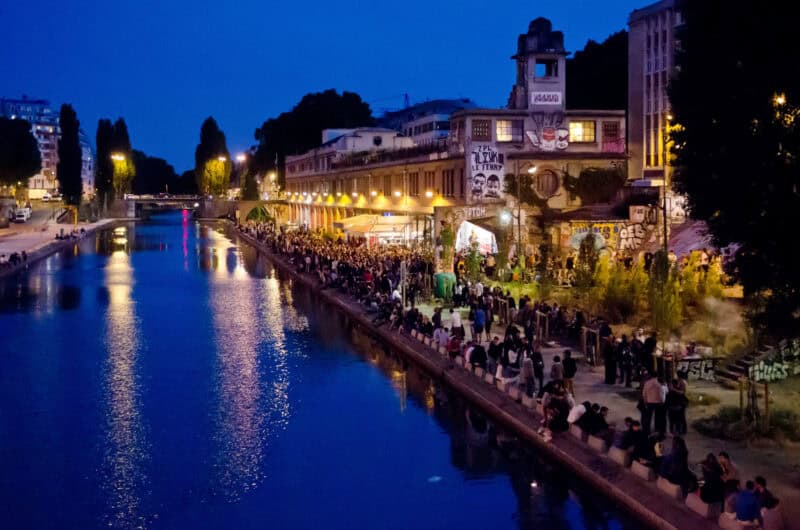 View of the Seine River at night near St Christopher's Paris - Canal with people enjoying the rivers.