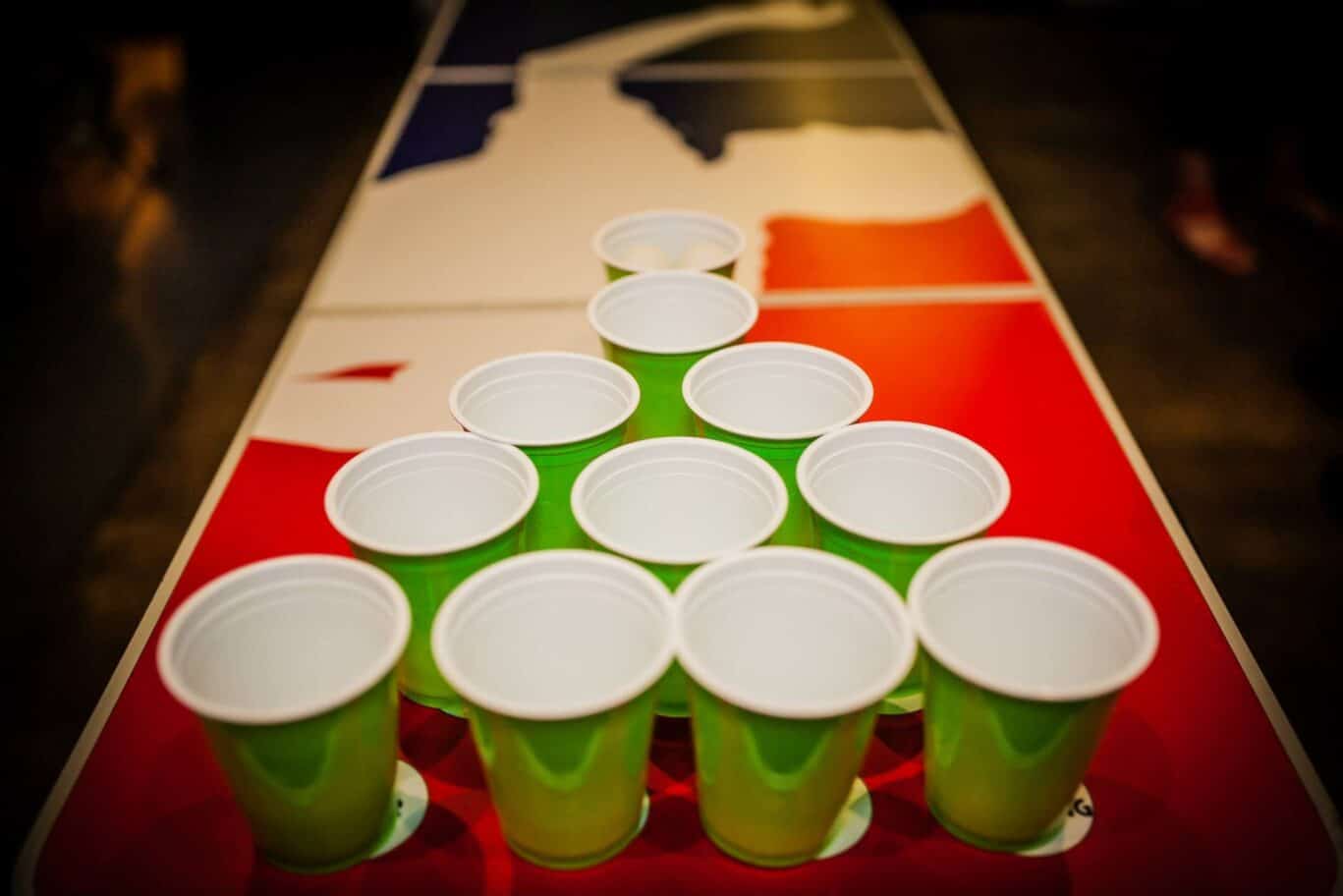 Party cups on a table with a colourful map design, representing social gatherings at St Christopher’.