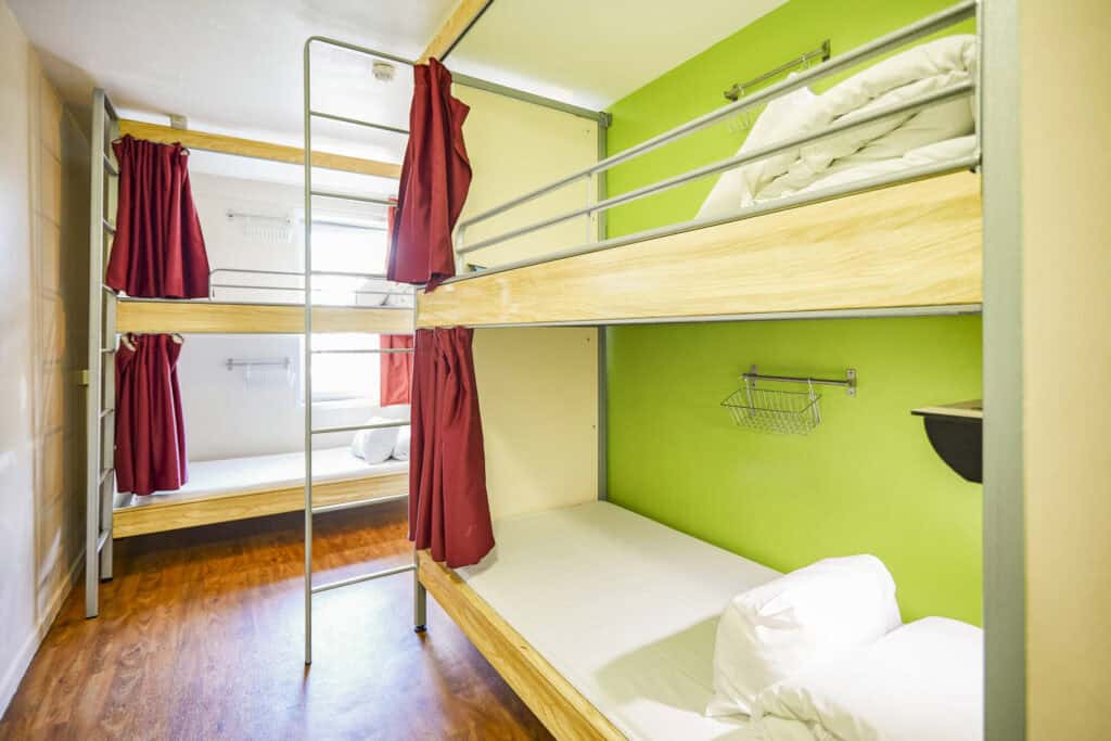 Bunk beds in a colourful hostel dorm room near Canal Saint-Martin, Paris.