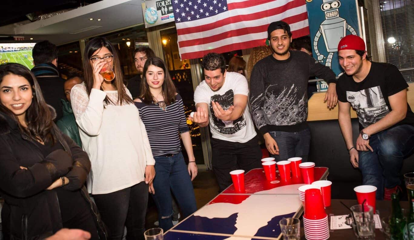 Group of young people enjoying a party at St Christopher’s Paris hostel.
