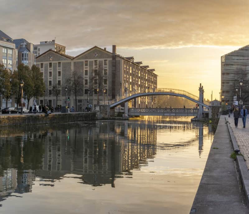 View of the Seine River and buildings near St Christopher's Paris - Canal at sunset.
