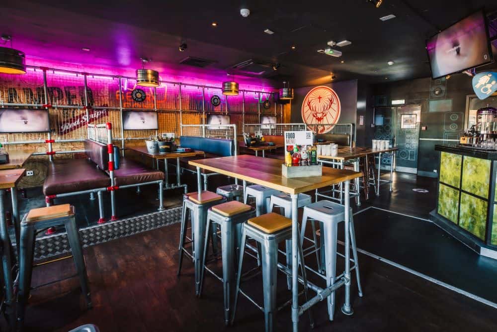 Interior view of Shepherd's Bush Hostel with modern decor and vibrant lighting.