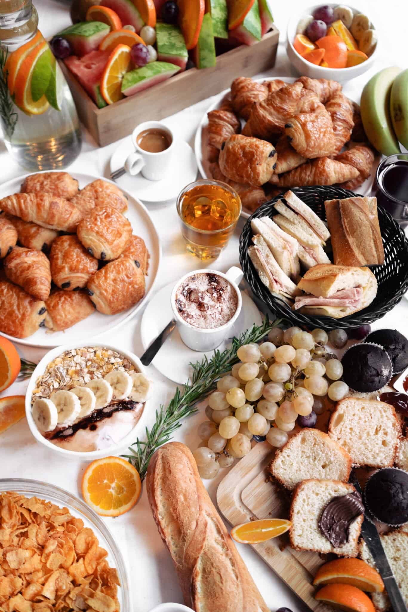 Delicious breakfast spread with pastries, fruits, and beverages at Shepherd's Bush Hostel.