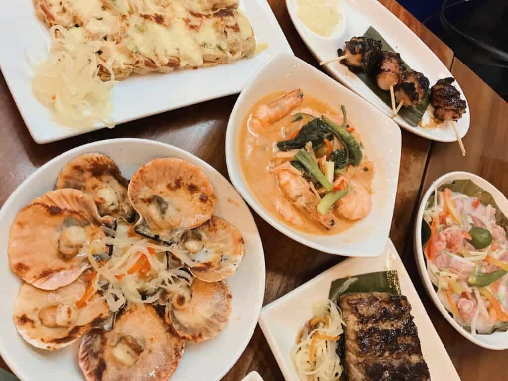 Authentic Asian dishes including dumplings, skewers, and salads served at Mitte Hostel, Berlin.