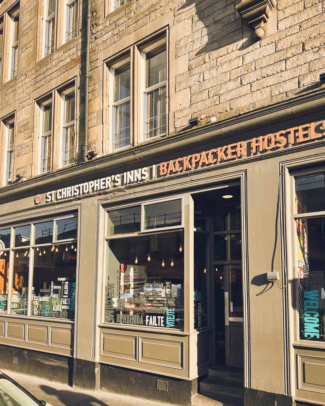 Exterior view of St Christopher's Backpacker Hostel in a historic building, welcoming travellers.