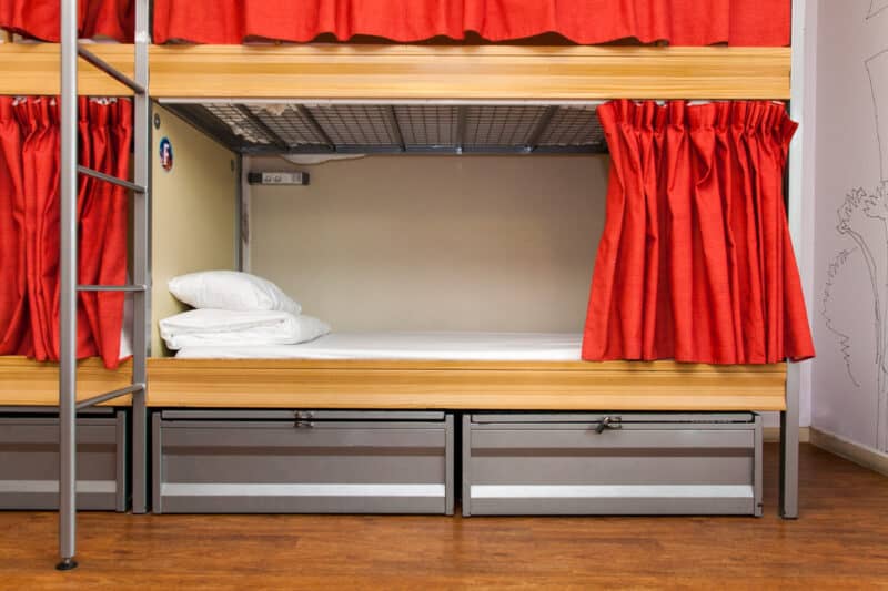 Bunk bed with red curtains at St Christopher’s Berlin - Mitte.