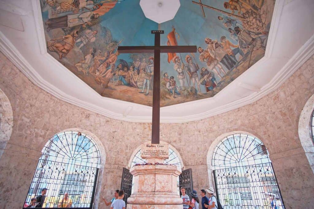 Interior of St Christopher’s Berlin church with a large cross and historic murals.