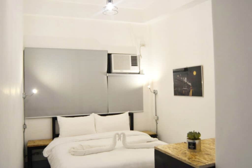 Modern hostel room with comfortable bed and minimalist decor in Berlin Mitte.