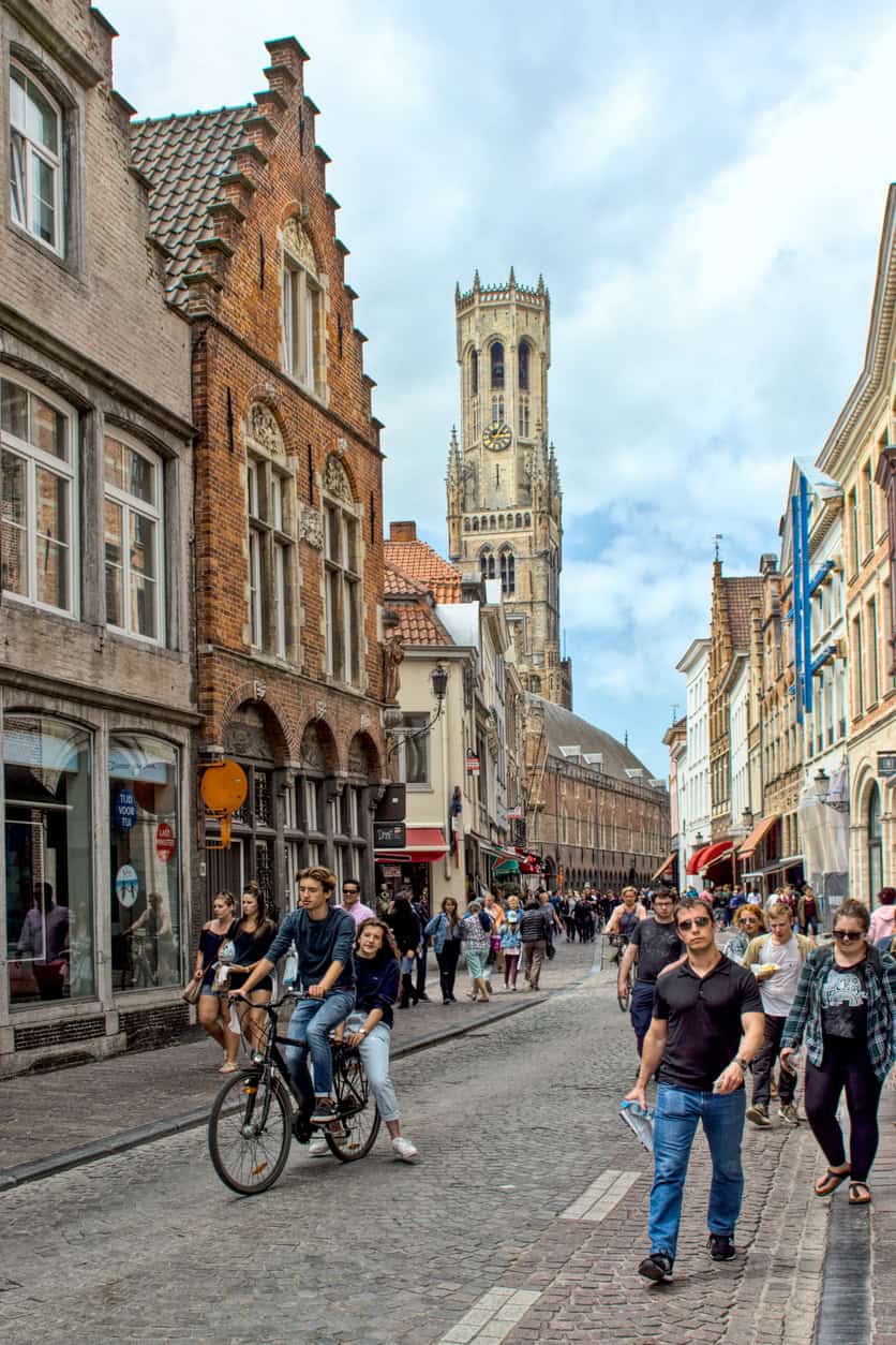 Historic St Christopher's Church tower in the background with lively city street in the foreground.