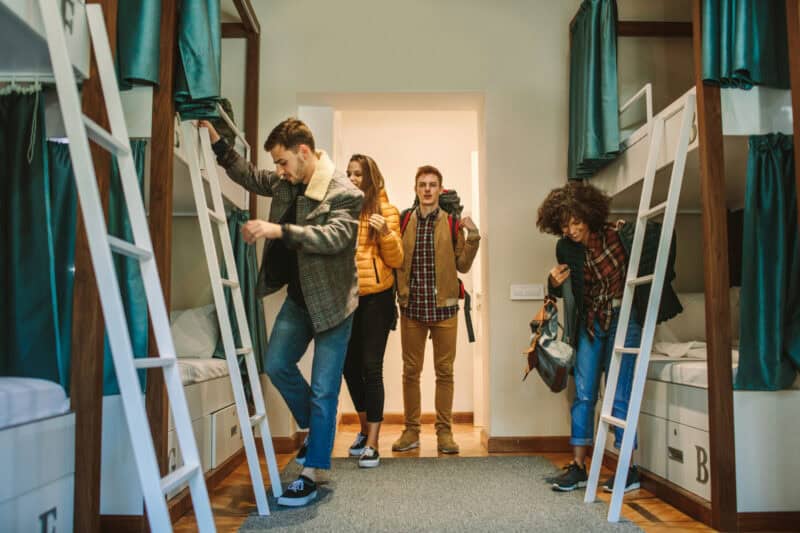 Young travellers exploring hostel dorm beds at St Christopher’s Berlin Mitte.