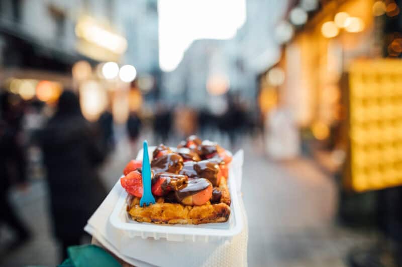Vibrant street food scene in Berlin with a focus on local snacks and lively atmosphere.