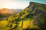 Scenic view of St Christopher's Hill with lush greenery and walking paths in Edinburgh, Scotland.
