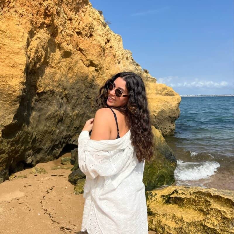 Woman in white dress enjoying coastal scenery at St Christopher's.