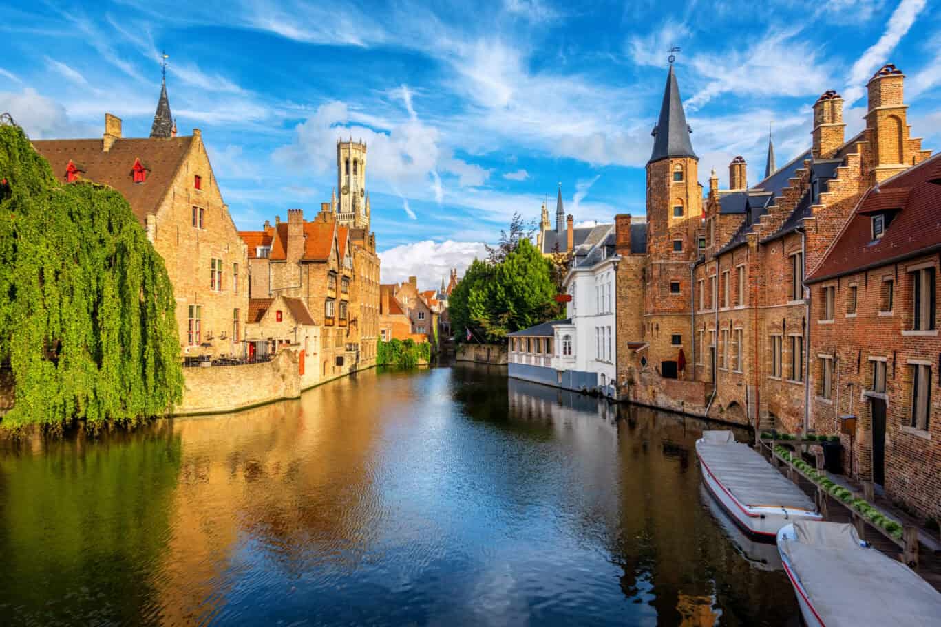 Bruges canal with the Belfry tower beyond – affordable hostel accommodation in Brugge right in the heart of the city