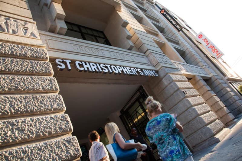 Entrance of St Christopher's Inn with people waiting outside the building.
