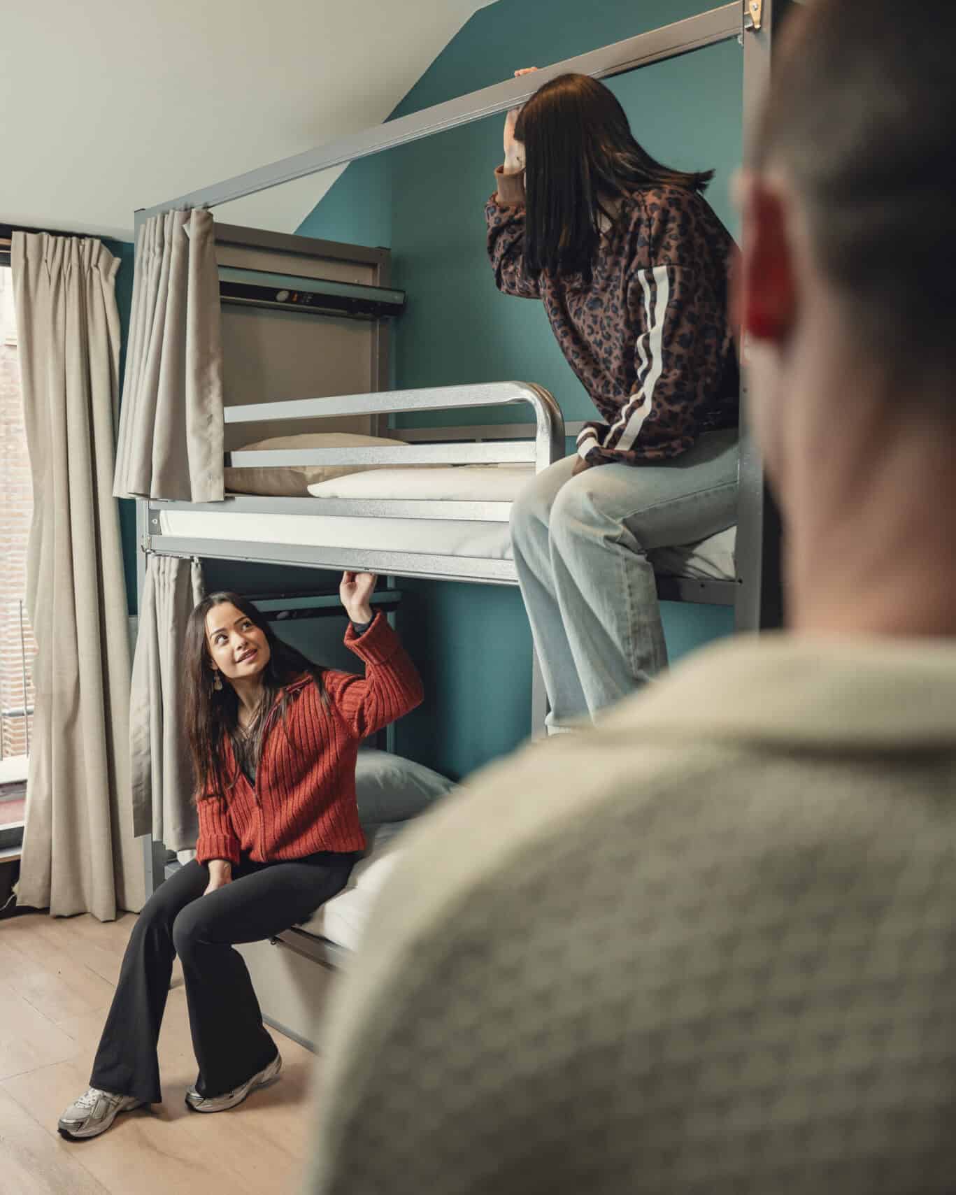 Hostel room at St Christopher's with bunk beds and guests relaxing.