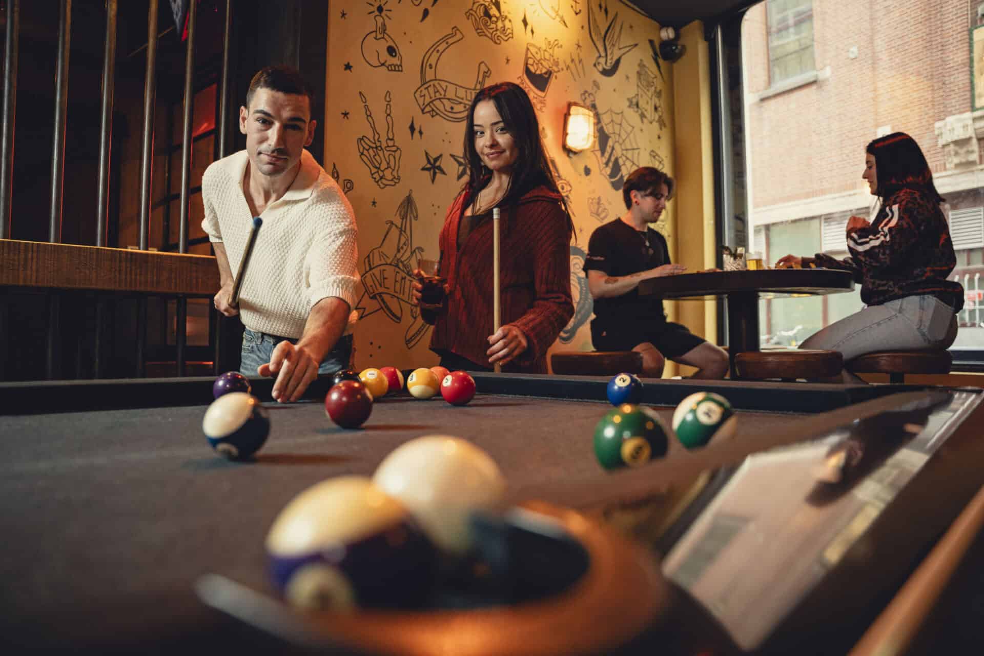 Pool table game at St Christopher's bar with friends enjoying leisure time.
