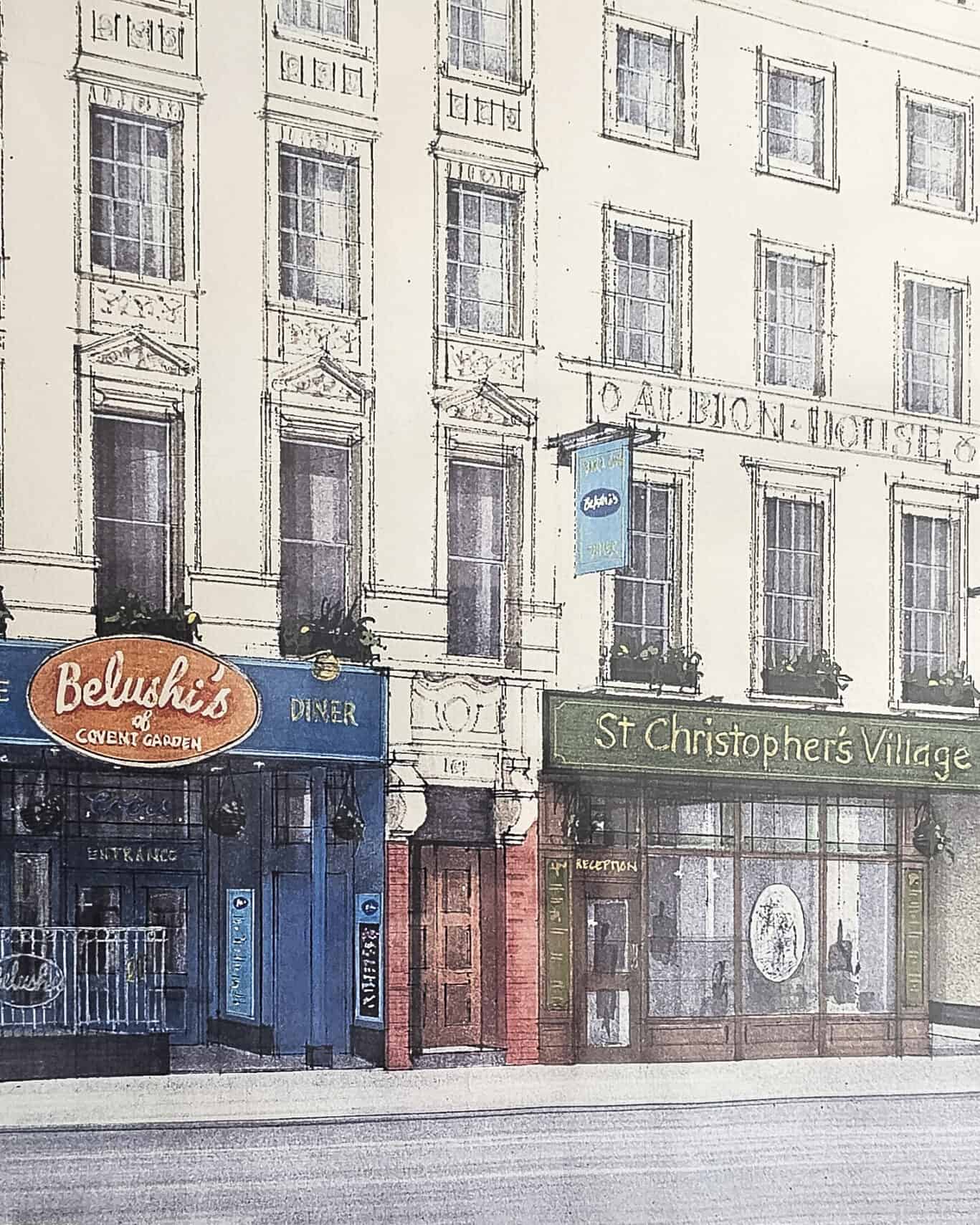 View of St Christopher's Berlin - Mitte hostel on a city street with shops and signs.