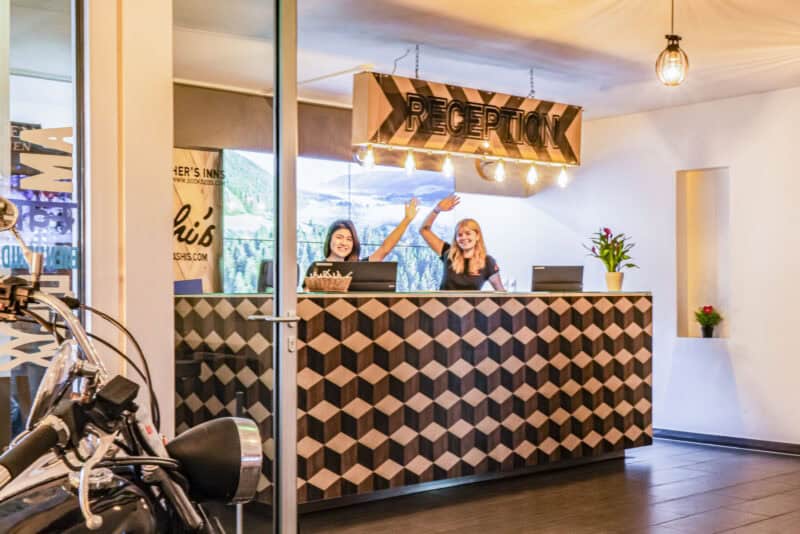Reception desk at St Christopher’s Vienna hostel with friendly staff welcoming guests.